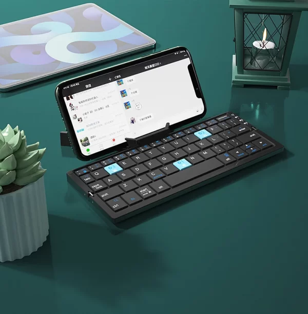 Mini teclado bluetooth dobrável com suporte para telefone celular. - Image 8